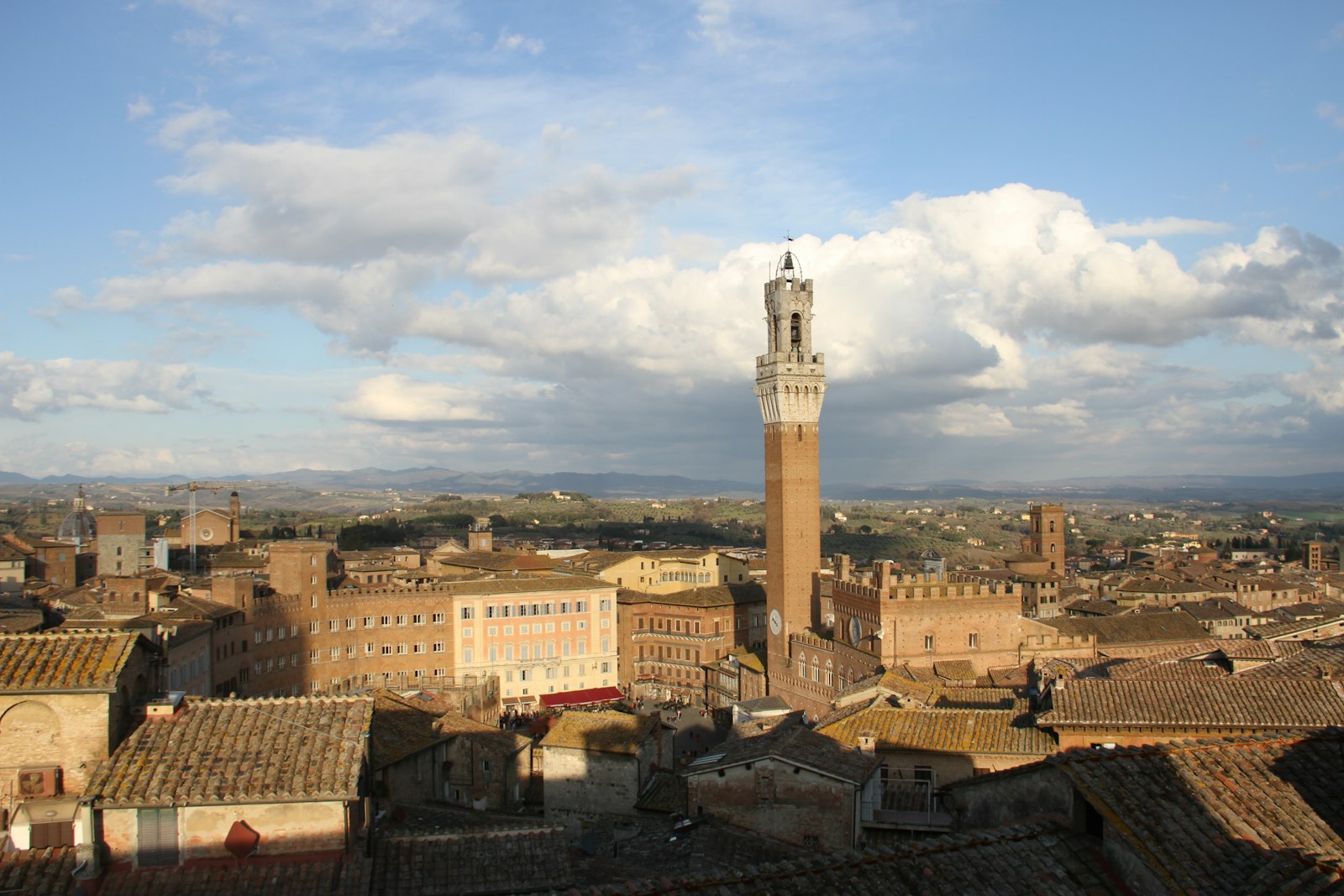 Siena's Torre del Mangia rising over the Piazza del Campo and the medieval city. Photo by aitac on Unsplash.