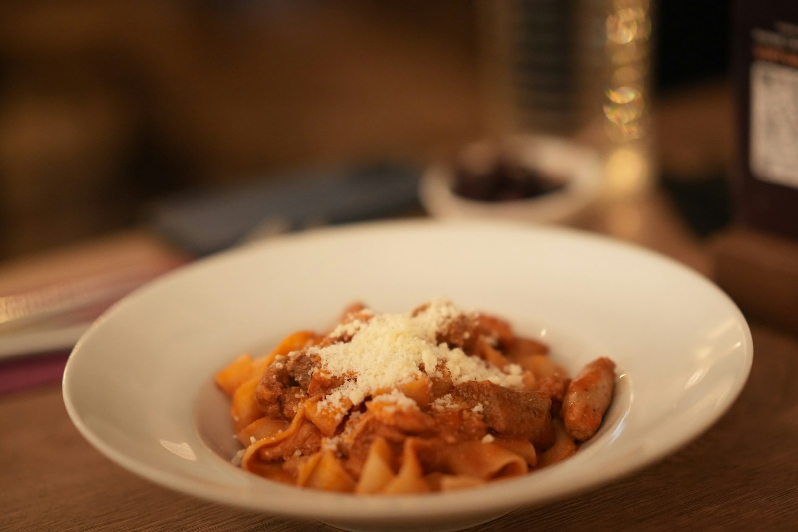 A plate of pasta under a rich meat ragù. Photo by Small Giant on Unsplash.