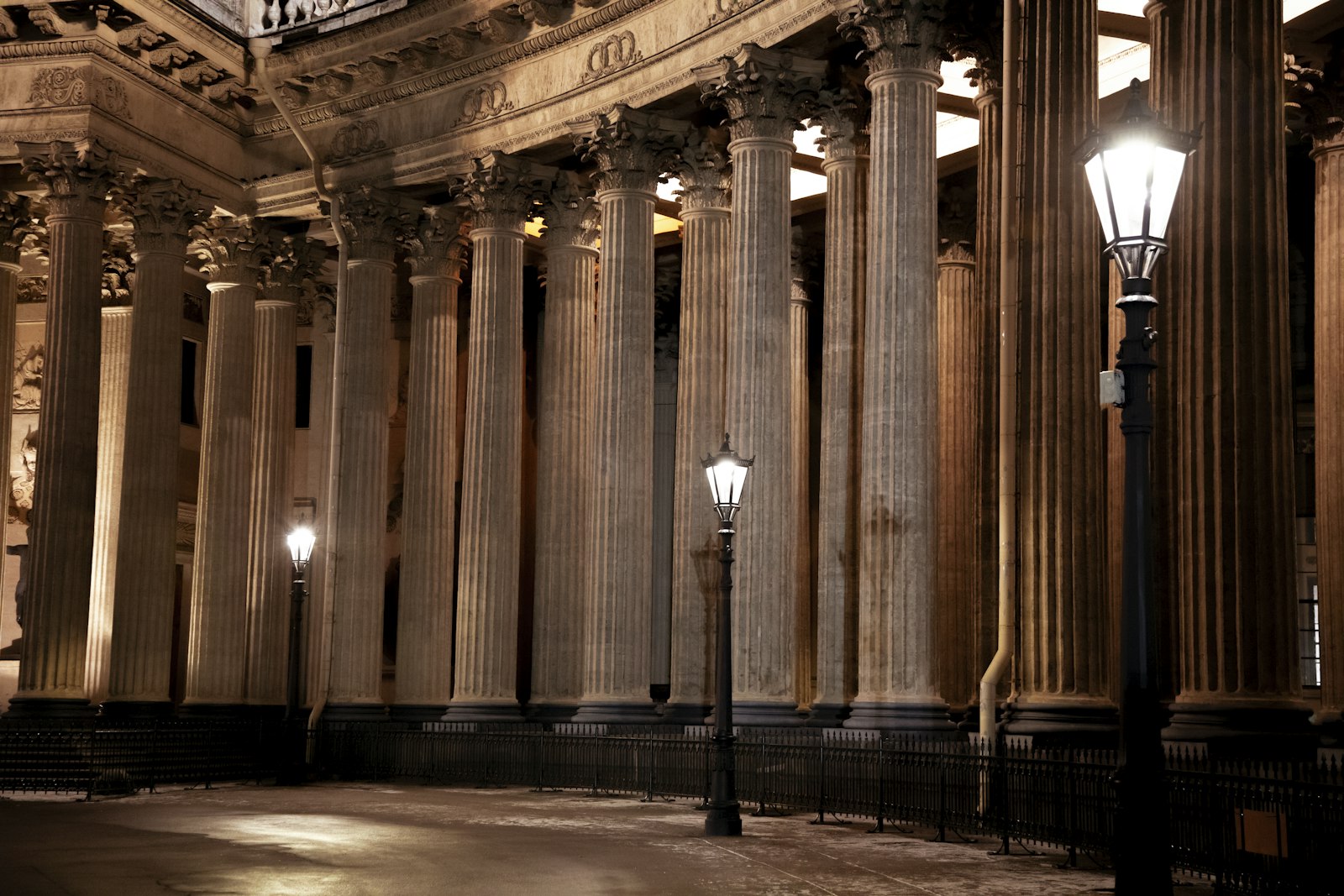 The lamplit columns of a grand neoclassical theatre at night in Bordeaux. Photo by Belov Sergey on Unsplash.