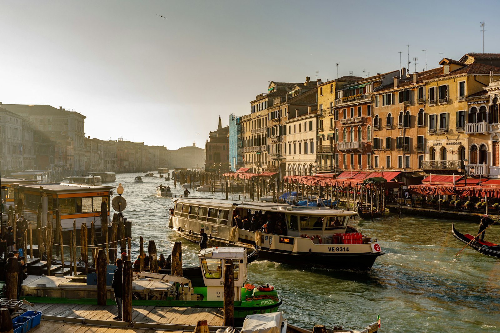 A vaporetto water bus pulls in along a busy stretch of the Grand Canal. Photo by Henri Picot on Unsplash.