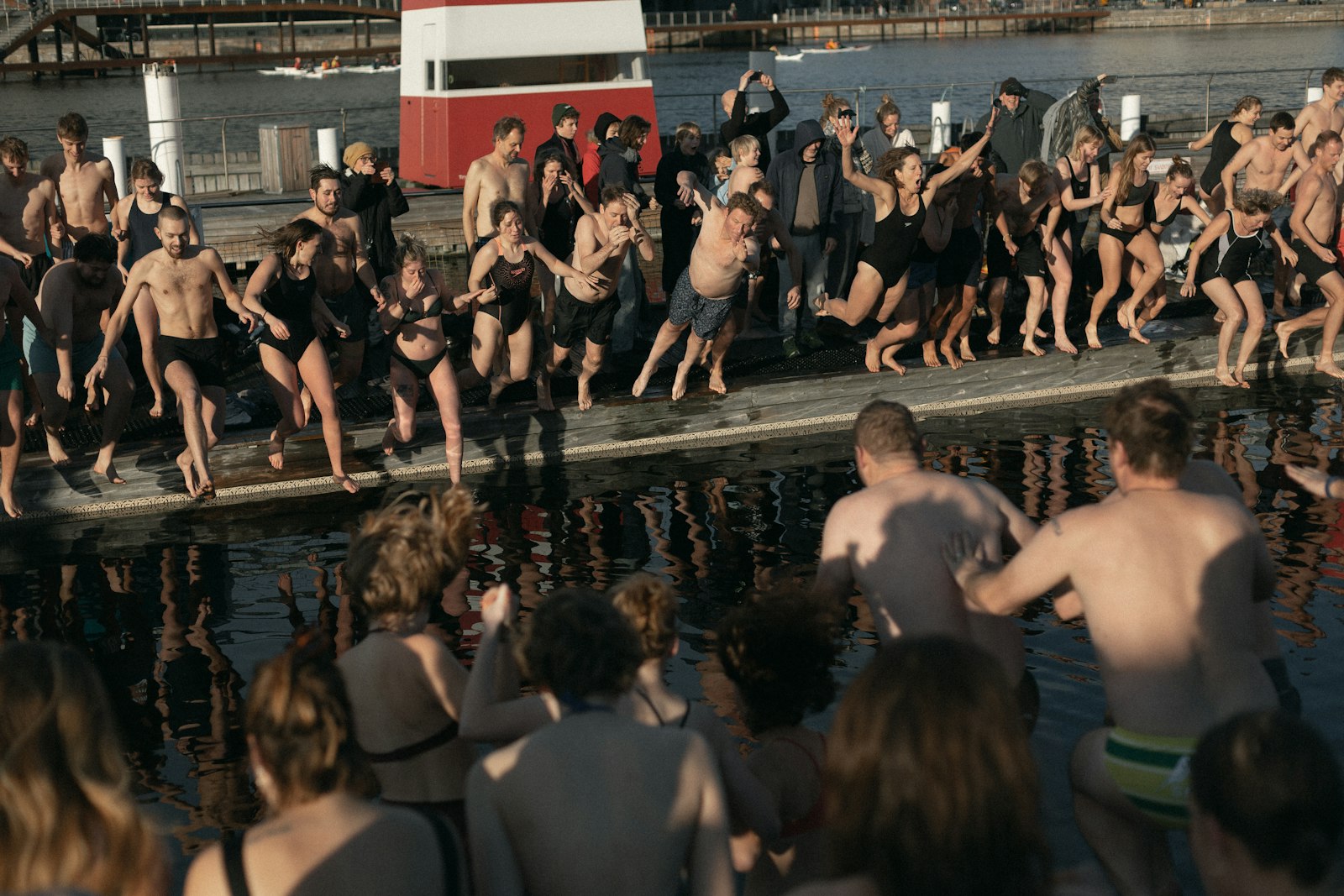 A group of friends about to jump together into the harbour bath at Islands Brygge, Copenhagen. Photo by Brian Kyed on Unsplash.