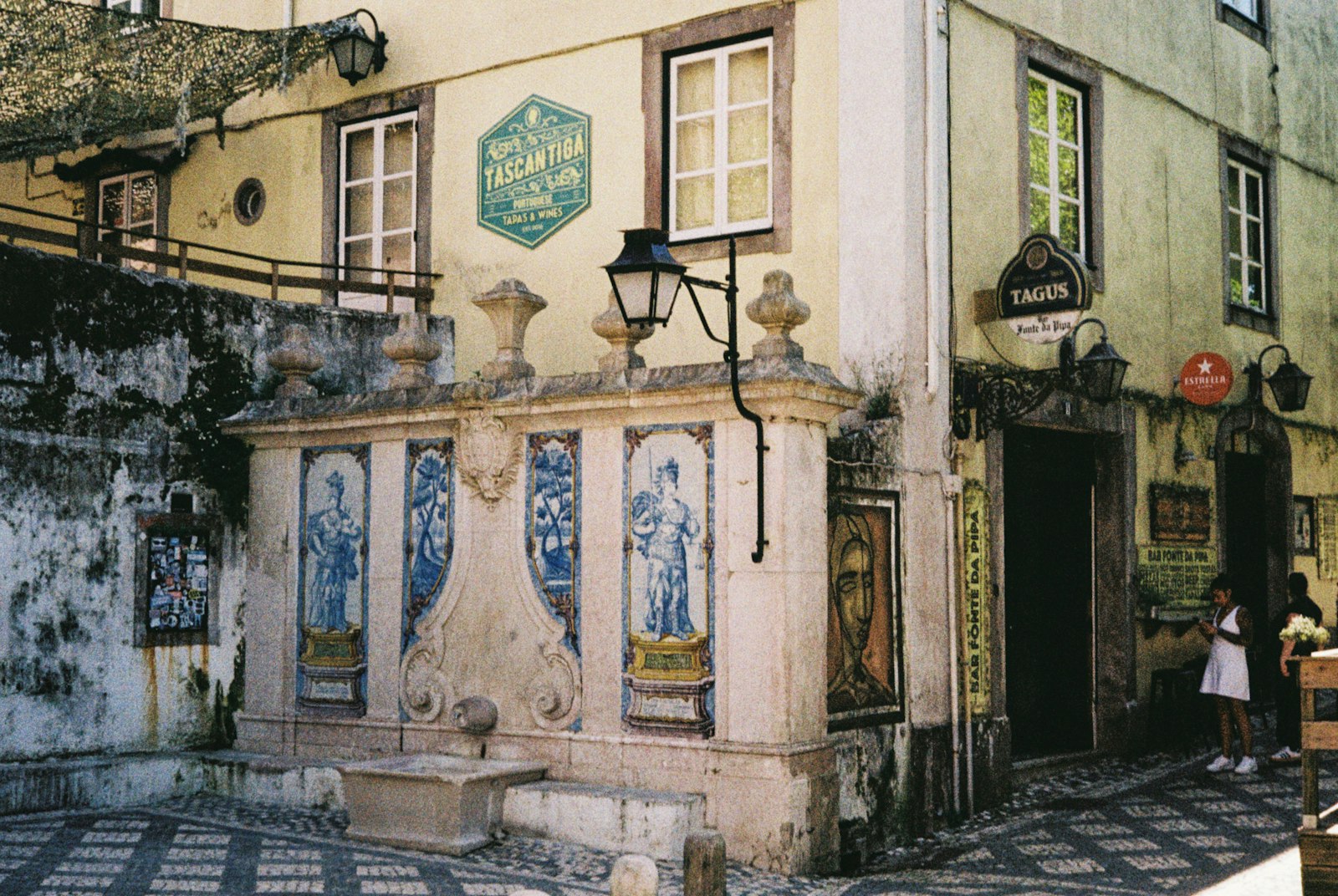 A tiled facade on a quiet cobbled lane in old Lisbon. Photo by Nico Knaack on Unsplash.