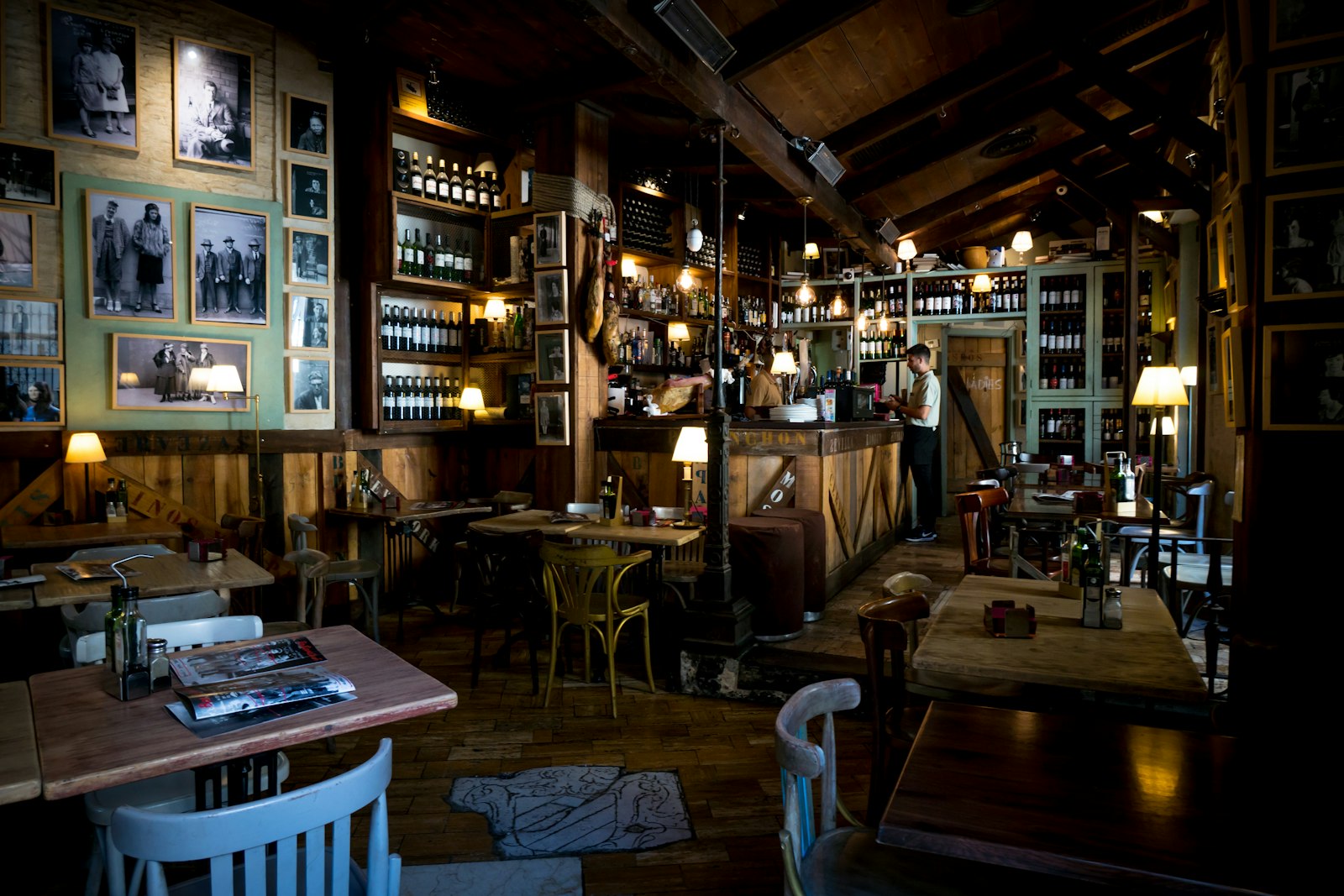 El interior de madera y botellas de una taberna vieja al final del día. Foto de Austin Gardner en Unsplash.