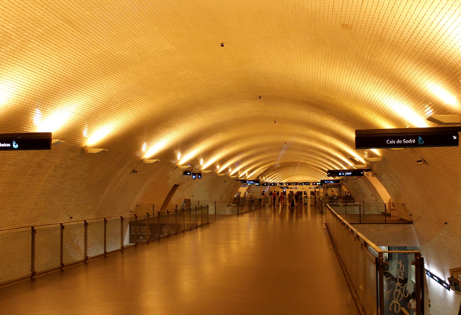 The warm-lit vaulted platform of a Lisbon Metro station. Photo by Heinz Reisenhofer on Pexels.
