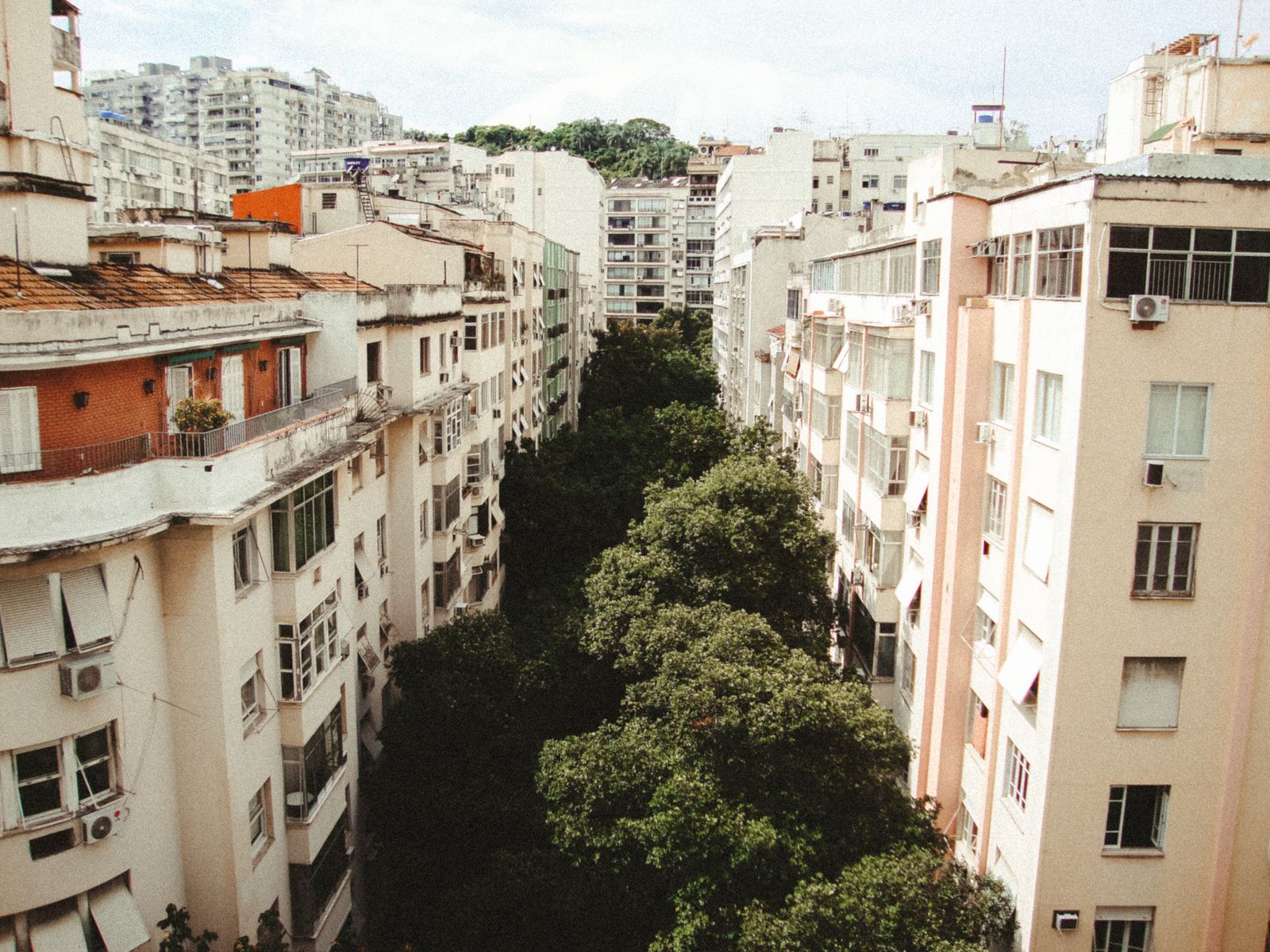 Apartment blocks and treetops in a residential district of Rio. Photo by Jonathan Borba on Pexels.