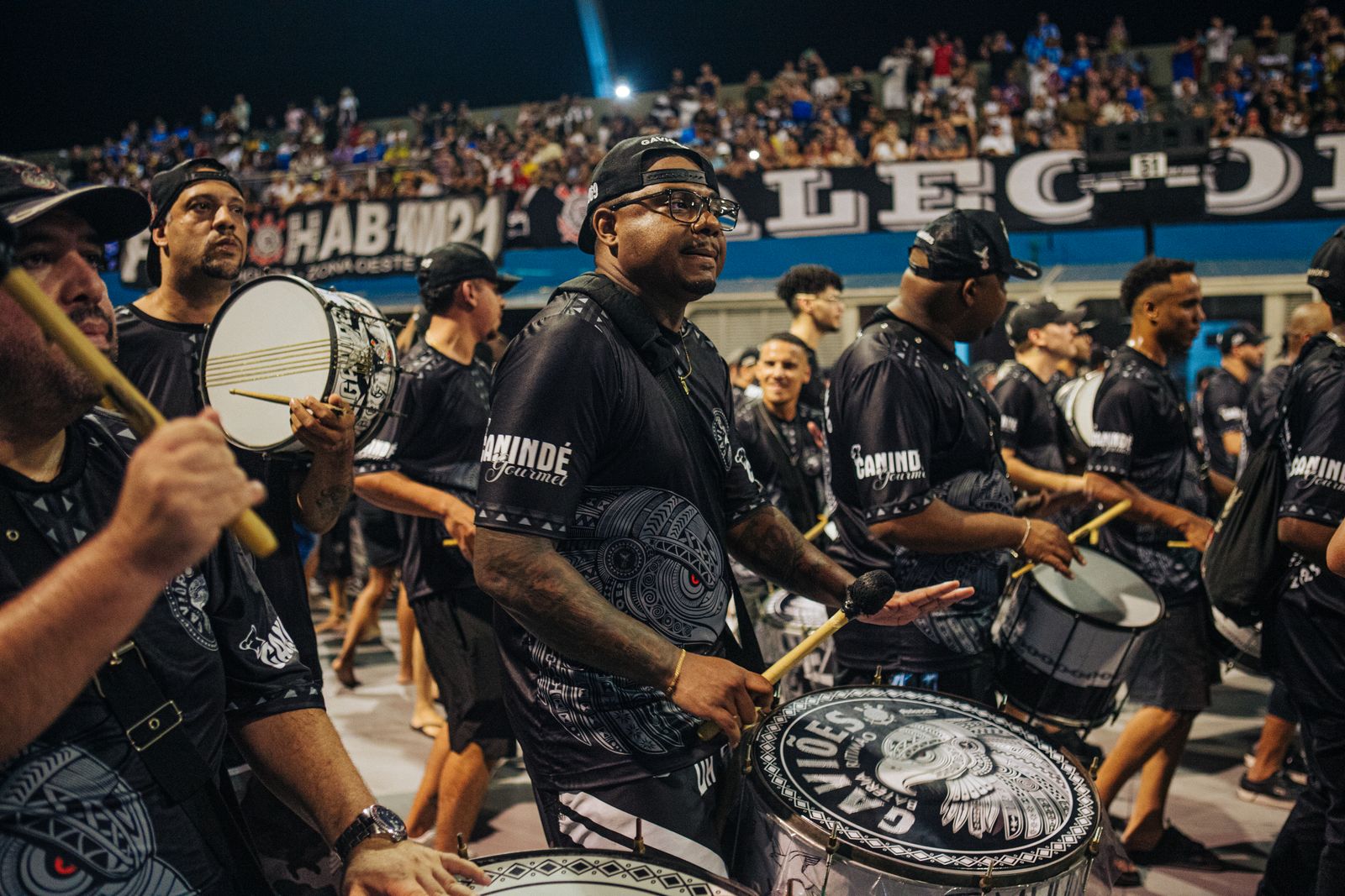 A samba percussion section playing, drums and hands mid-beat. Photo by Emanuel Pedro on Pexels.