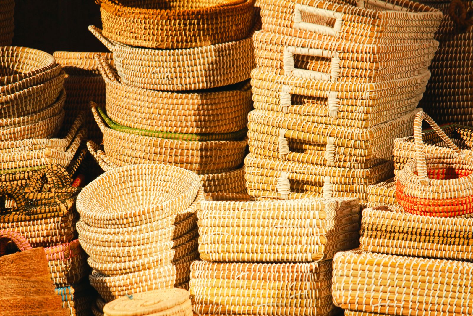 Stacks of handmade woven baskets in warm light. Photo by Sayeed Chowdhury on Pexels.