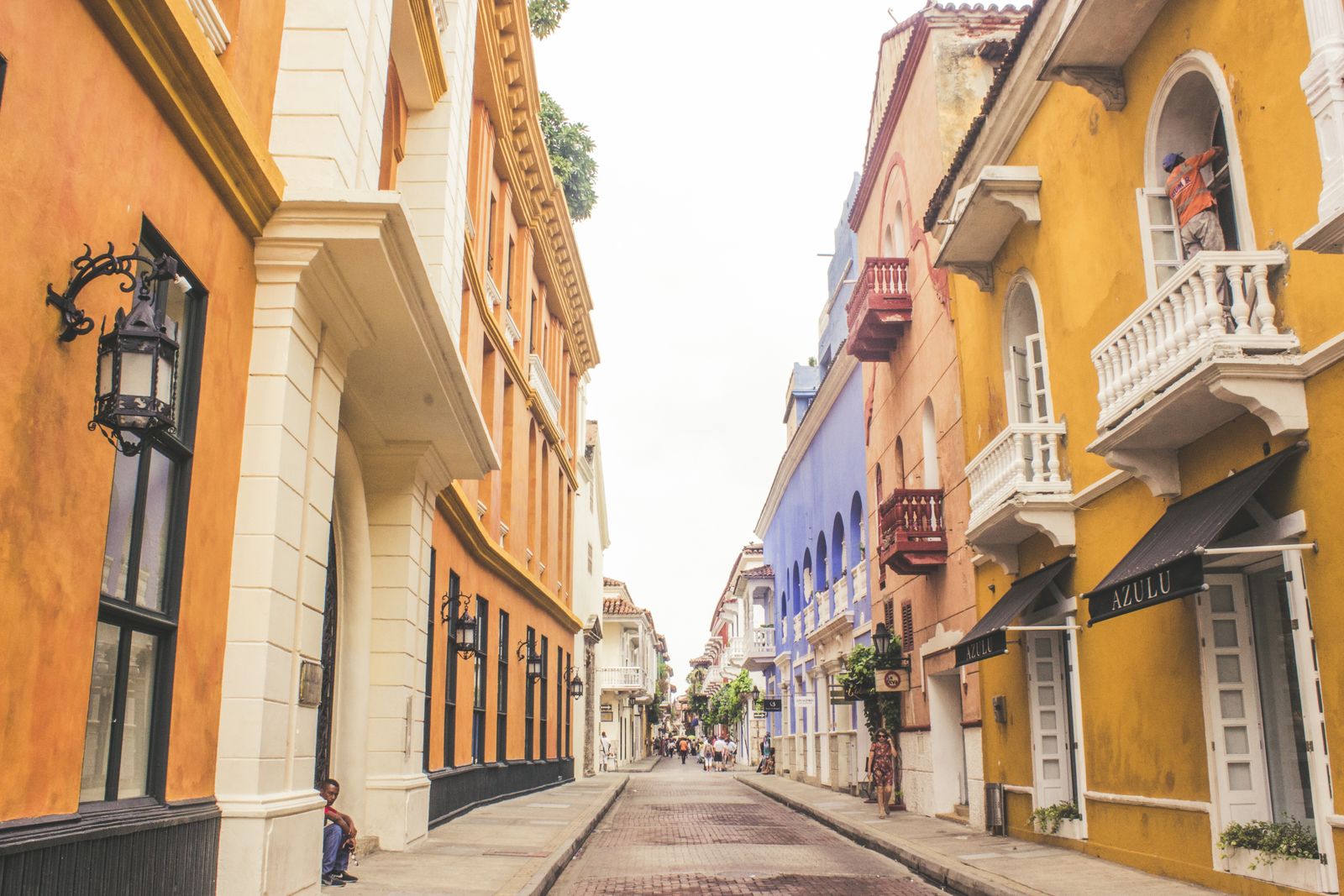 An ochre colonial street with wooden balconies in Cartagena. Photo by Maria Paula Medina on Pexels.