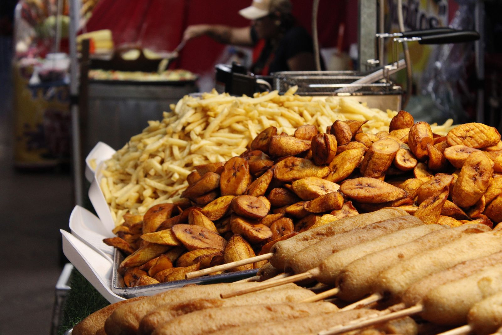 Fried plantain, chips and skewers on a street vendor's tray. Photo by Heidi Brittany Enríquez Esparragoza on Pexels.