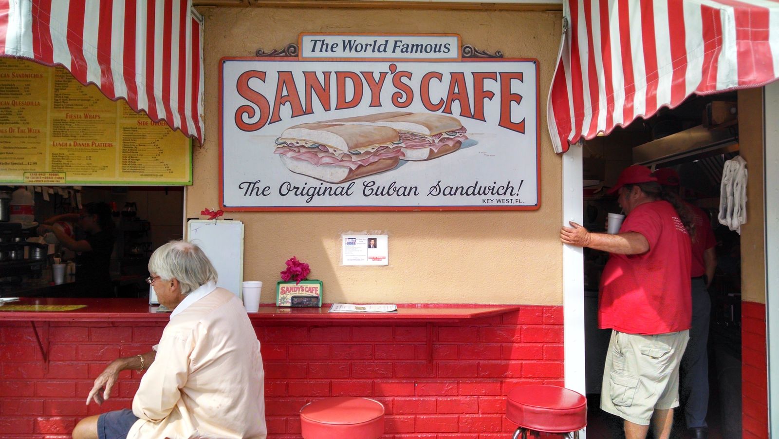 A Cuban sandwich counter in Miami with a red-and-white striped awning. Photo by Chris R. on Pexels.