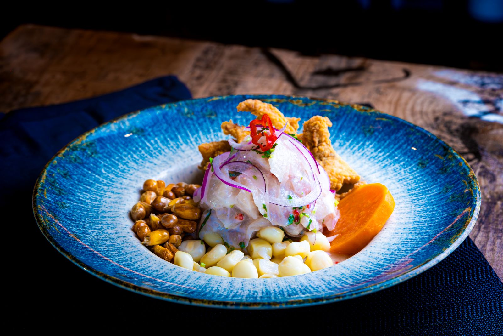 A plate of Peruvian ceviche with corn, onion and chilli. Photo by Nano Erdozain on Pexels.