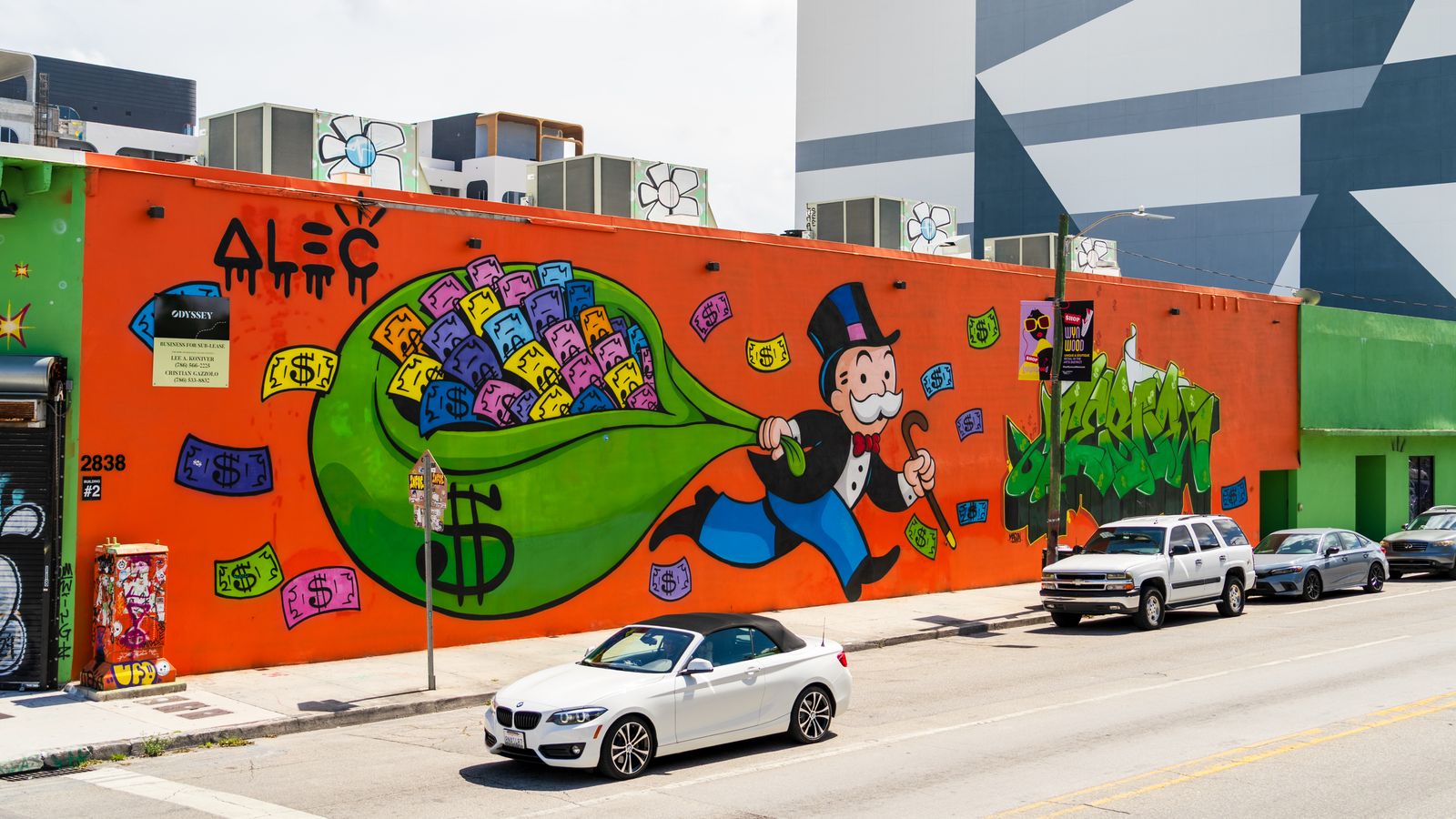 A large street-art mural on a wall in Miami with cars parked alongside. Photo by Abhishek Navlakha on Pexels.
