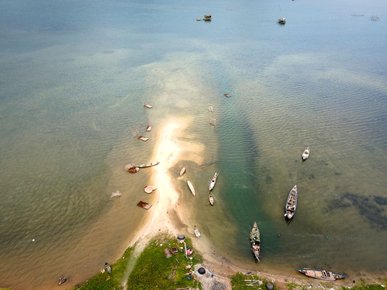 Small boats anchored in shallow water off a sandbar, seen from above. Photo by Quang Nguyen Vinh on Pexels.