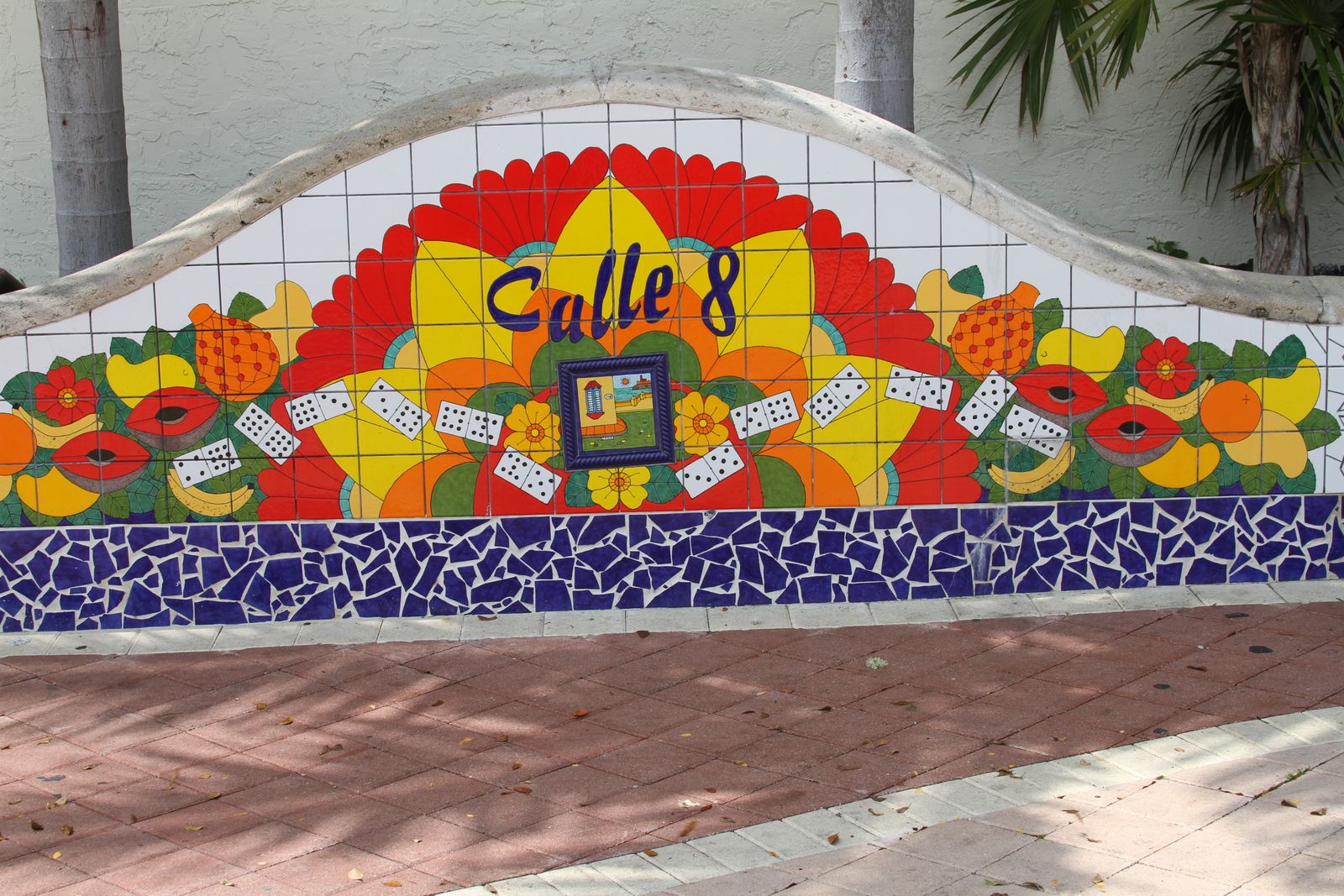 A mosaic mural in Little Havana, Miami, reading Calle 8, with dominoes and fruit. Photo by Diego Ferrari on Pexels.