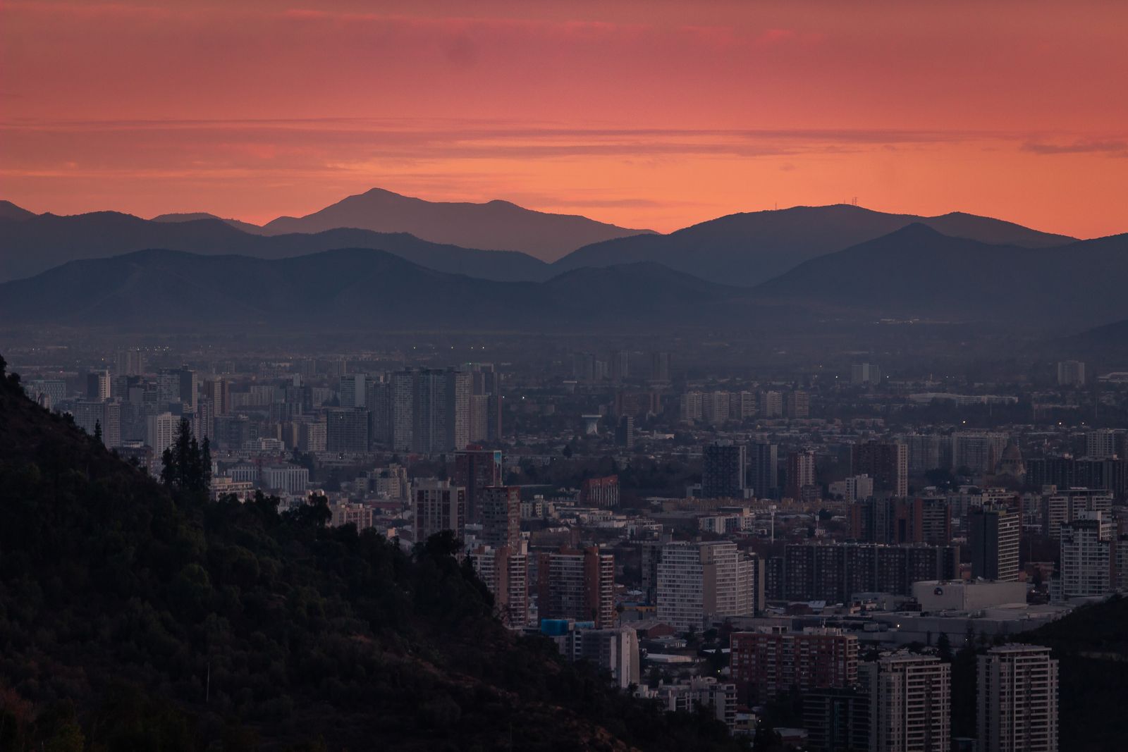 The Santiago skyline at dusk with the Andes standing behind it. Photo by Alexis Leandro Jeria Bocca on Pexels.
