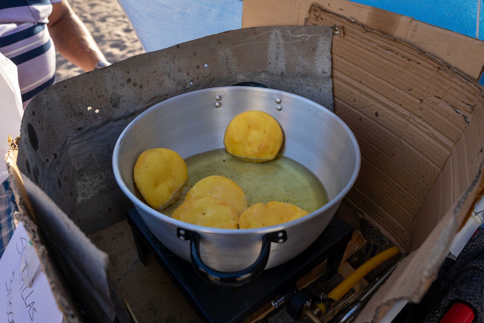 Sopaipillas frying in a pan at a street stall. Photo by Juan Moccagatta on Pexels.
