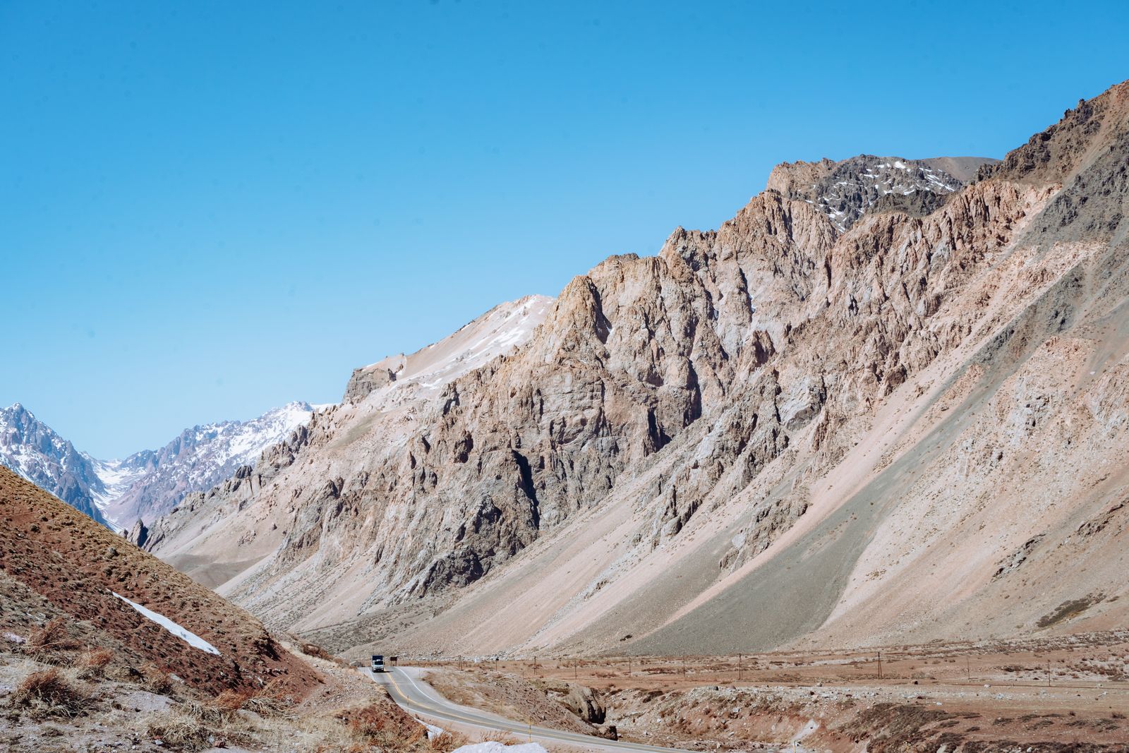 The highway climbing through the bare Andes toward the pass, at Los Penitentes. Photo by Andres Alaniz on Pexels.