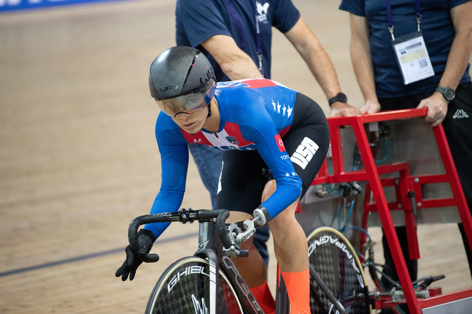 Katie Walker competing on the velodrome in Team USA para cycling kit.