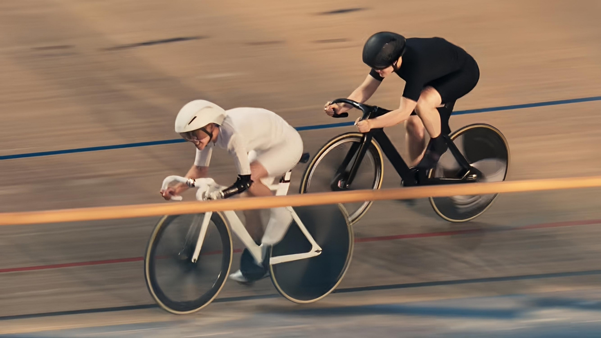 Katie Walker training on a track cycling bike during an indoor velodrome session.