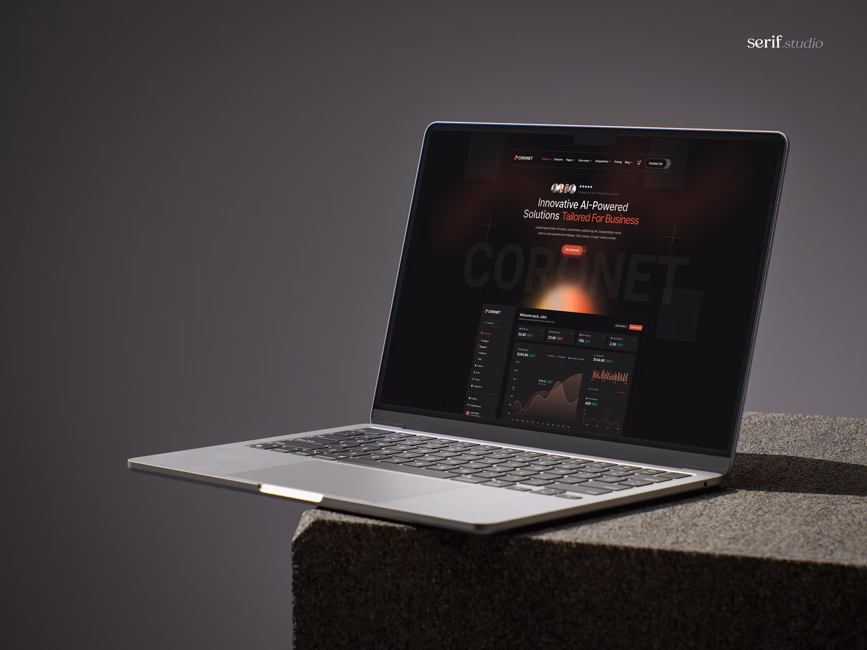 Silver laptop on a textured block showing a dark-themed AI-powered business dashboard on screen.