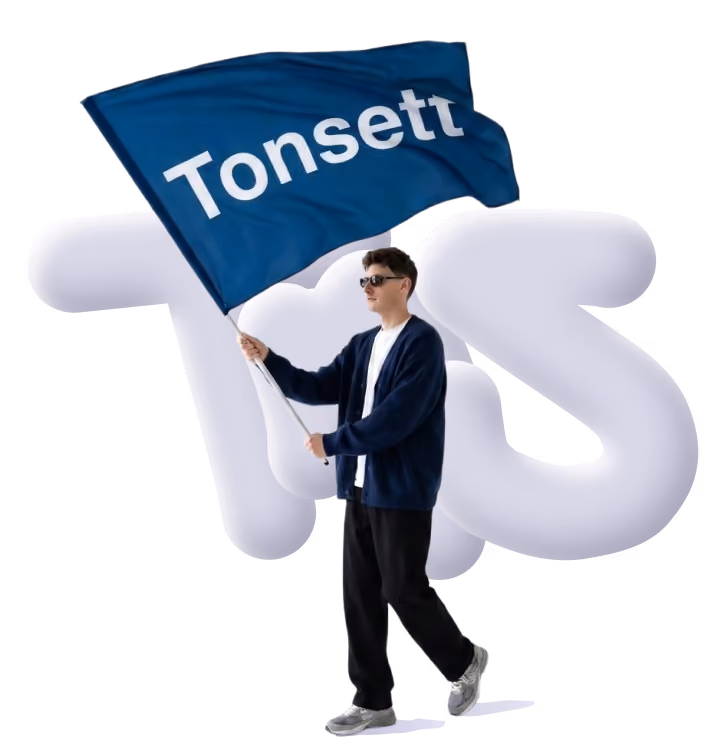 Person wearing sunglasses and dark clothes holding and waving a blue flag with the word Tonsett.
