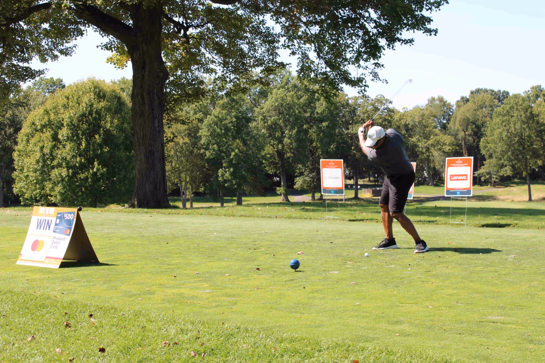 Kelser Corporation IT managed services golf tournament sponsorship event with Lenovo signage on sunny course