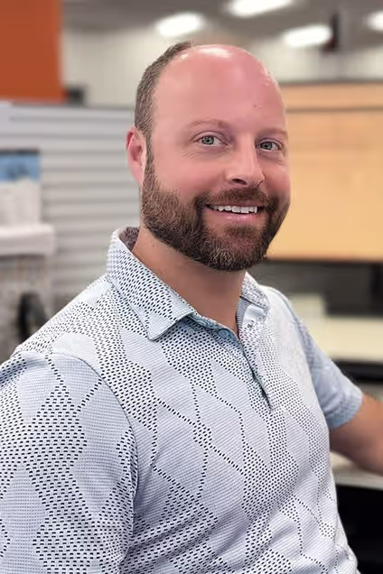 Kelser Corporation IT support team member smiling in office environment