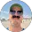 Man smiling outdoors at beach in sunlight, casual professional headshot for Connecticut IT support team