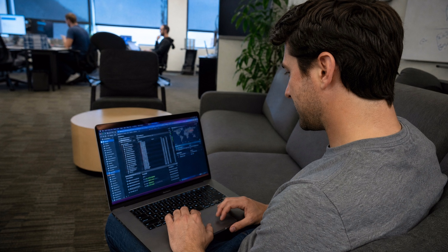 Man reviews digital security report on laptop at lounge