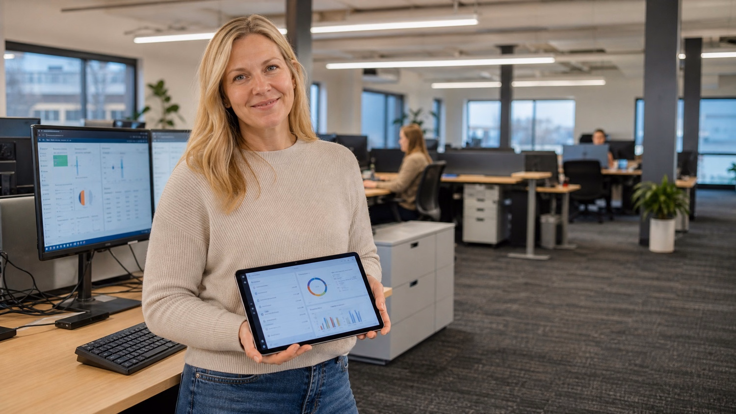 Woman reviews mobile security report at open office desk