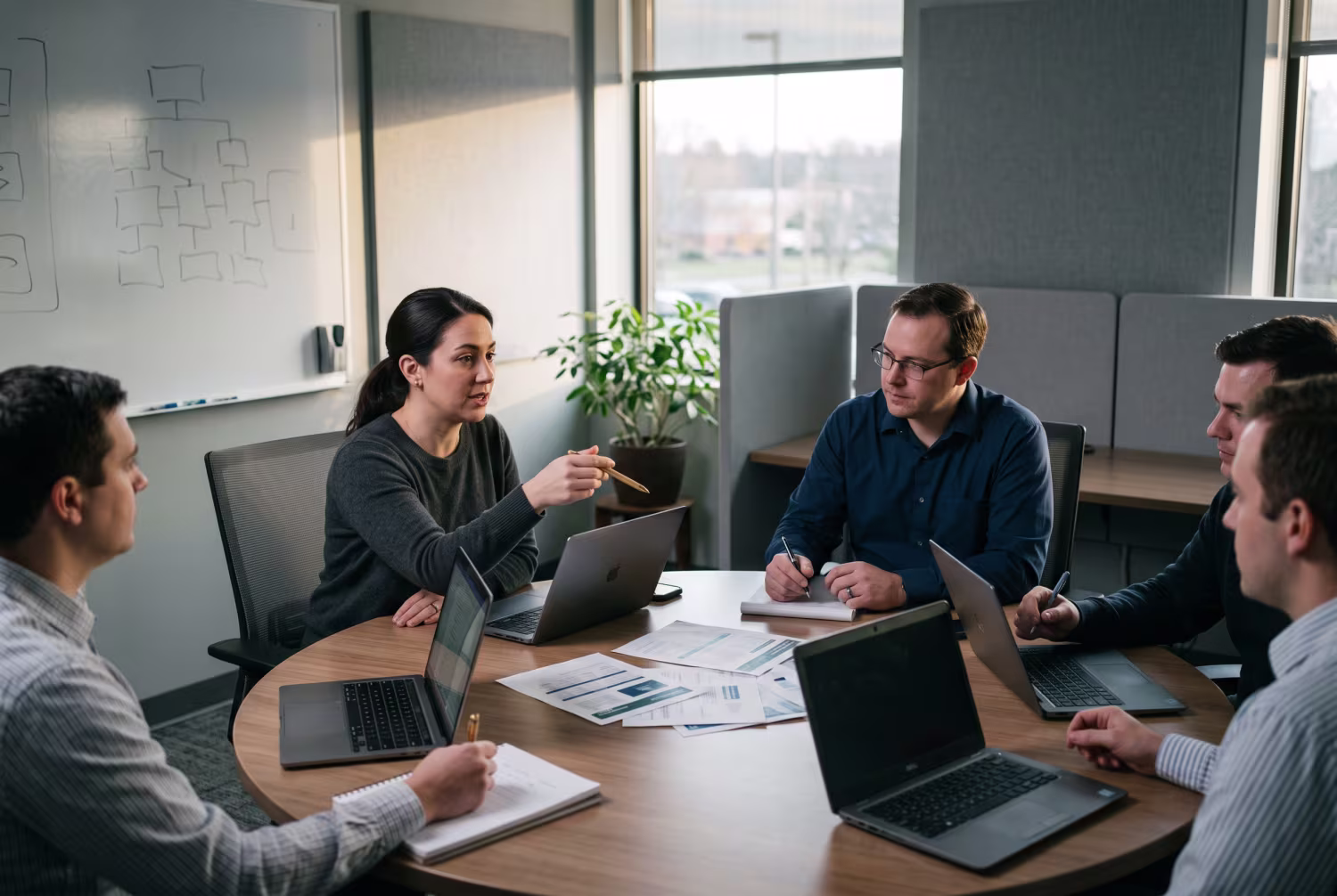 IT professionals discussing risk management strategies in office meeting