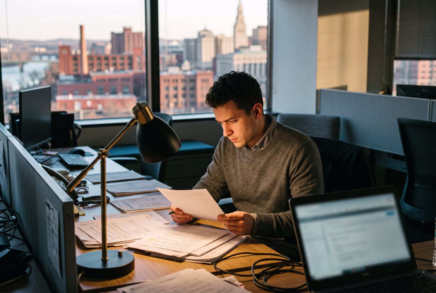 IT professional analyzing documents for risk management at desk