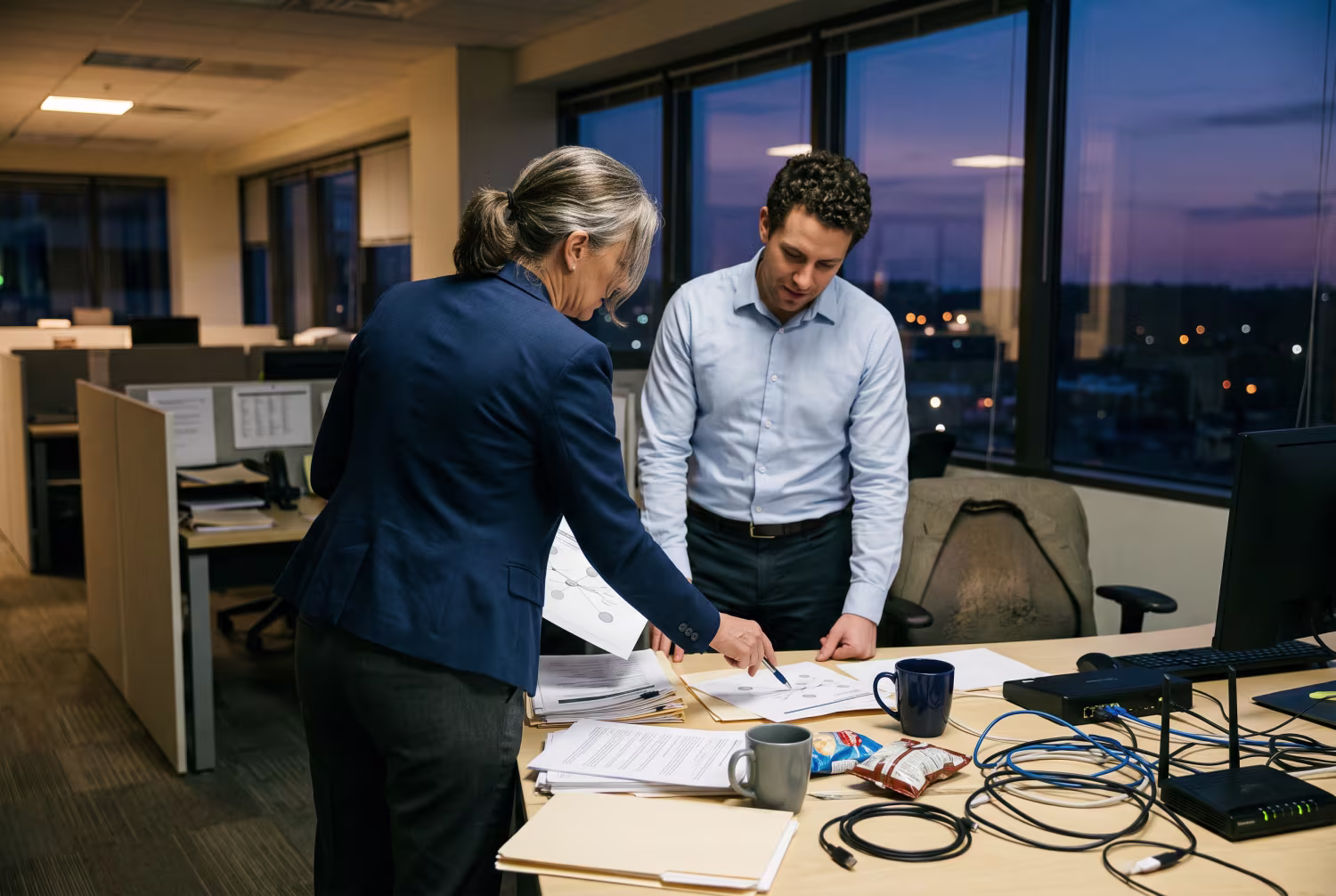 IT consultant reviewing network assessment in cluttered office