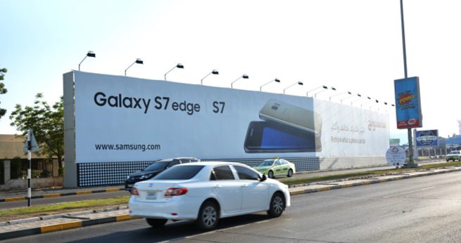 Large-format billboard advertising on a main road in Dubai