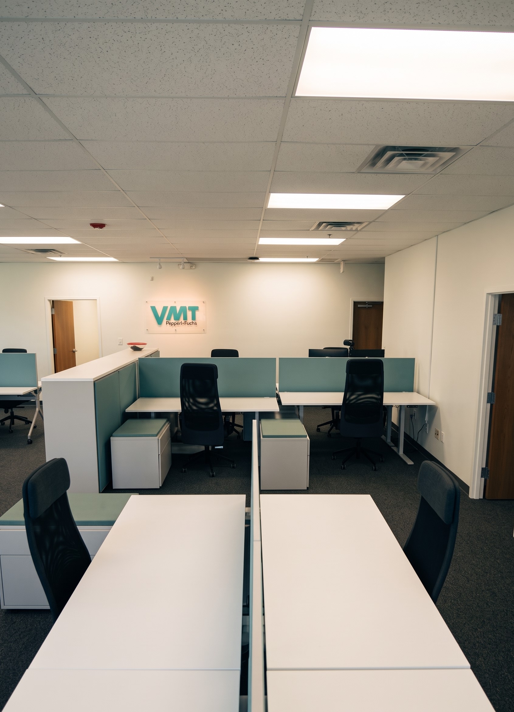 VMT Office in Spain. Empty Tables in a wide office room.