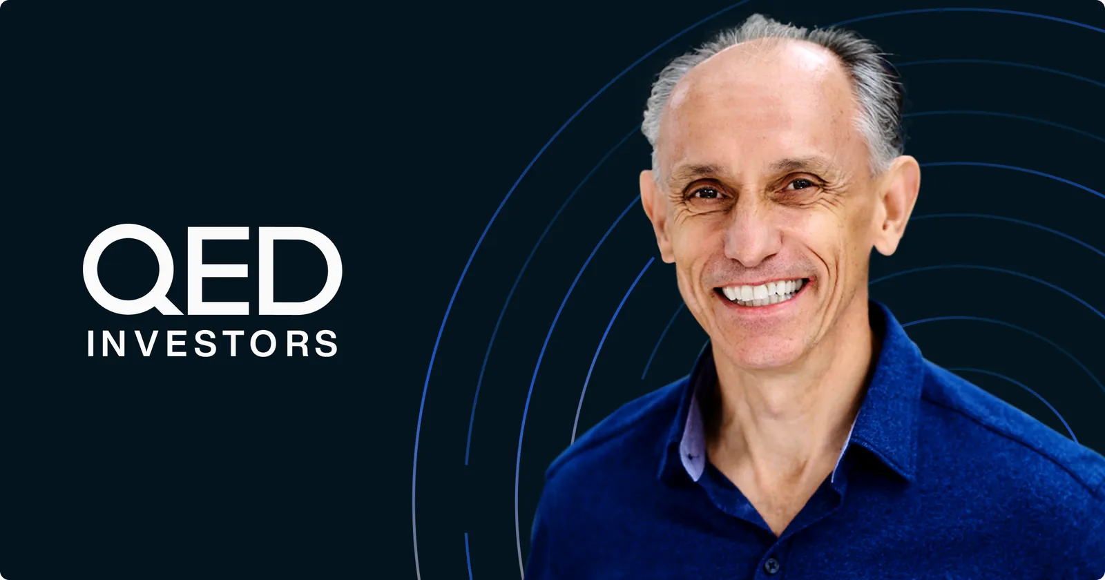 Nigel Morris of QED Investors, smiling, on a dark background beside the QED Investors logo