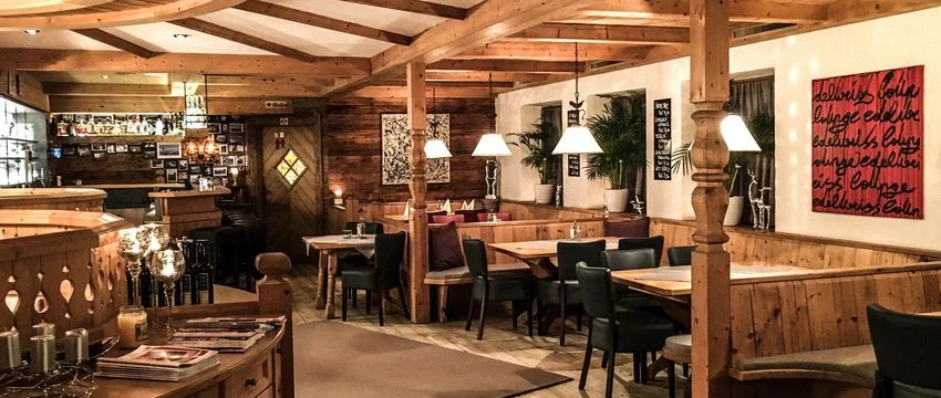 Edelweiss wooden-beam restaurant interior at the Mayrhofen hotel.