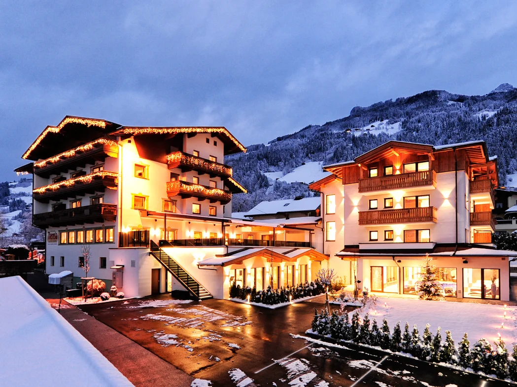 Hotel Theresia snowy alpine hotel exterior at night in Ramsau im Zillertal.