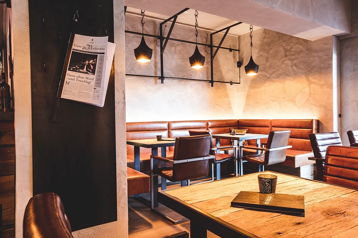 Perauer cozy cafe interior with leather seating at the Mayrhofen hotel.