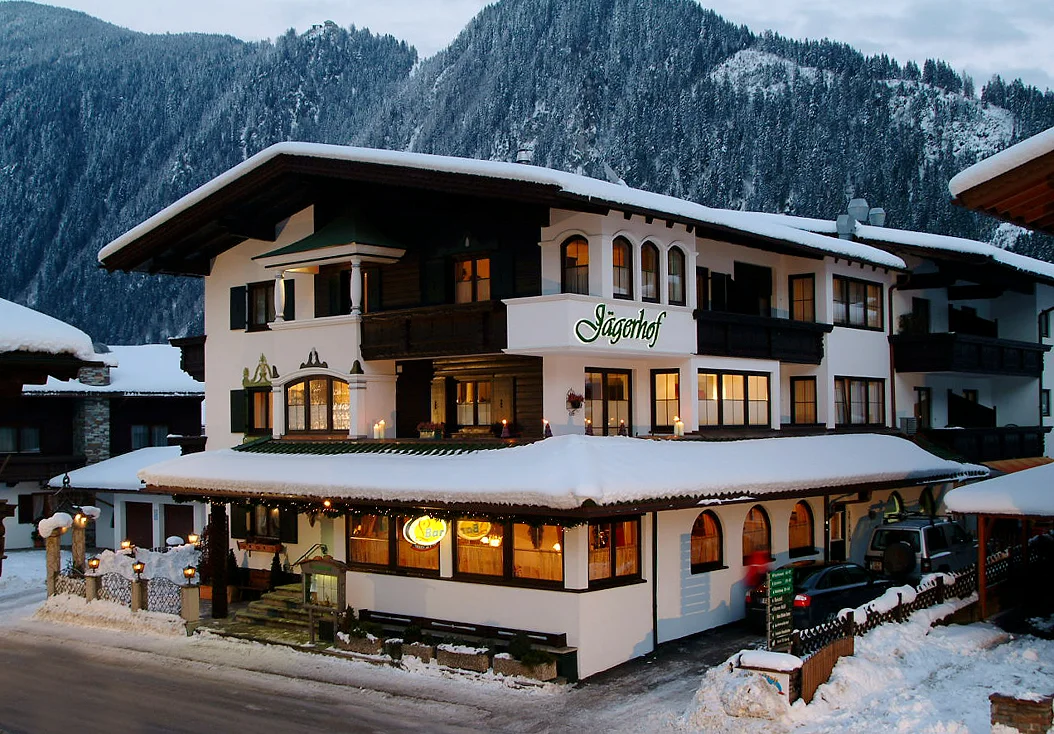 Jägerhof alpine hotel exterior in the snowy Mayrhofen mountain village.