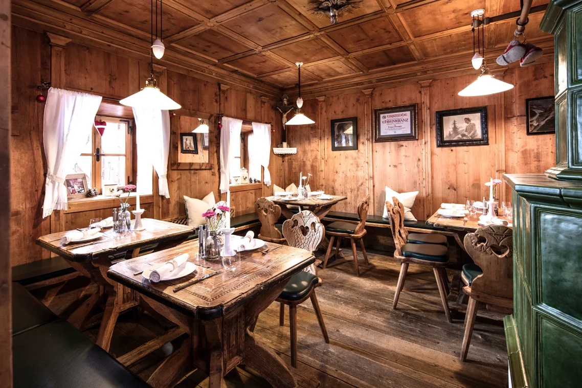 Perauer traditional wooden-tables restaurant interior at the Mayrhofen hotel.