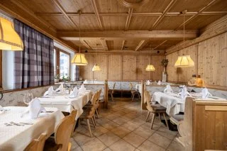 Eckartauerhof wooden-interior restaurant tables at the Mayrhofen hillside hotel.