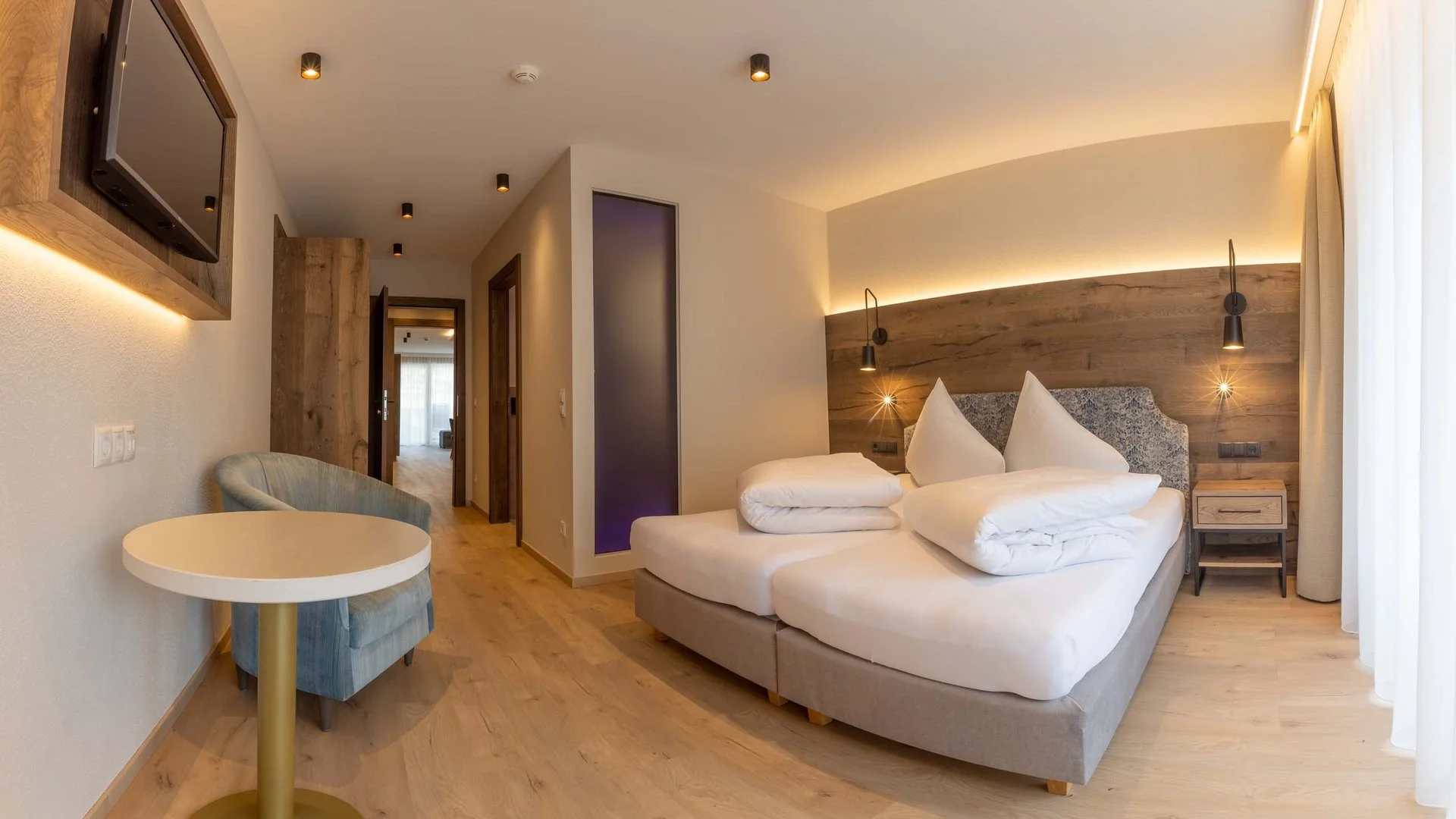 Strass Apartments modern bedroom with wooden headboard at the Mayrhofen self-catered apartment.
