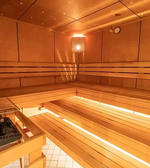 Sylvana's Hotel wooden sauna interior with lamps at the Mayrhofen boutique hotel.