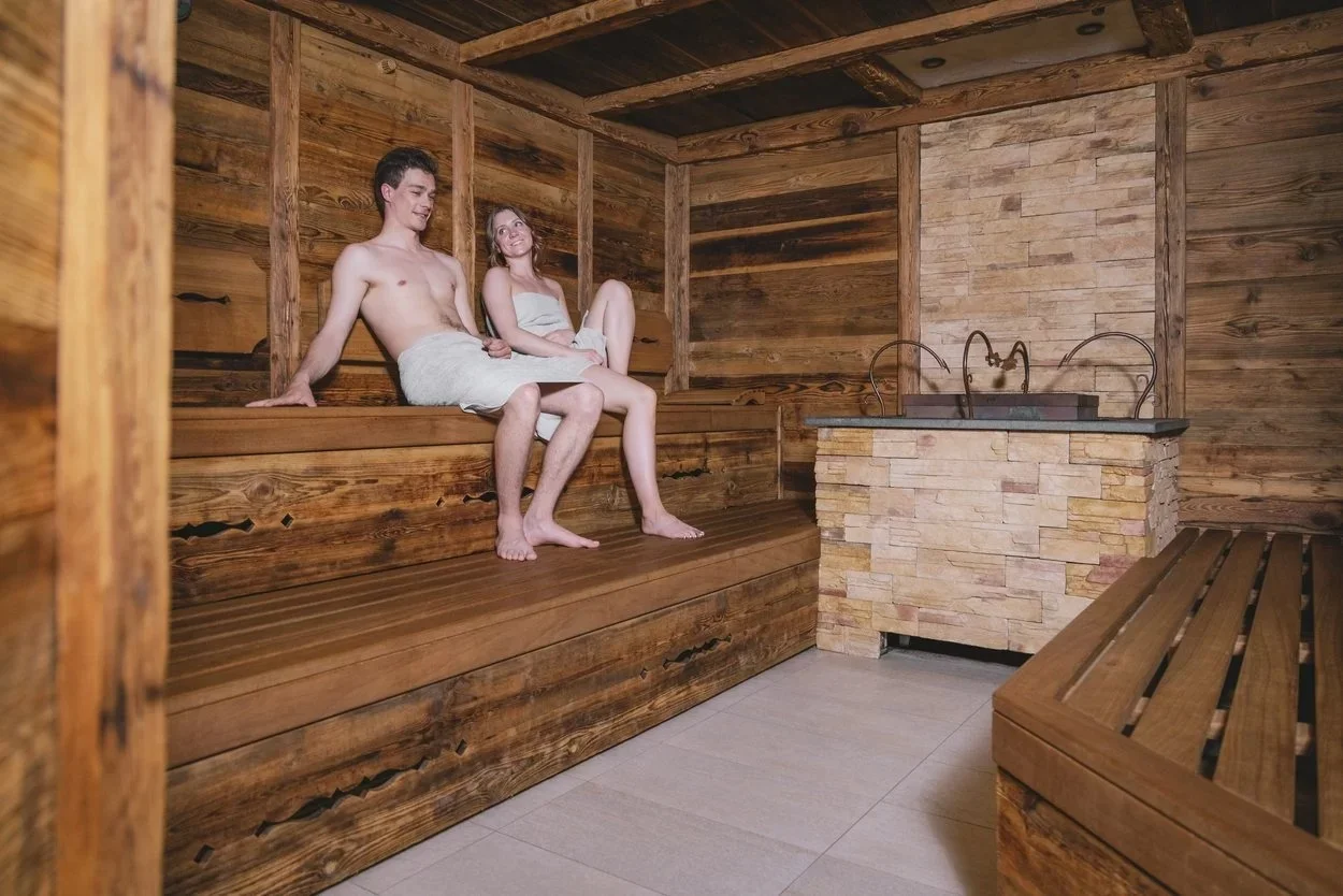 Hotel Strass couple relaxing in the wooden sauna at the Mayrhofen Sport and Spa.