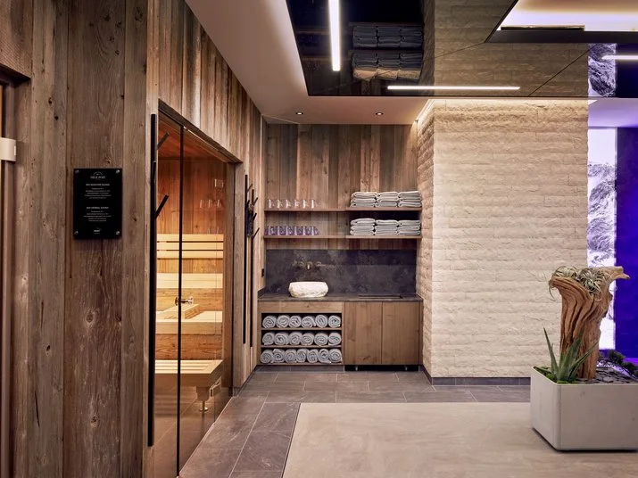 Neue Post modern wooden spa room with towels at the Mayrhofen four-star hotel.