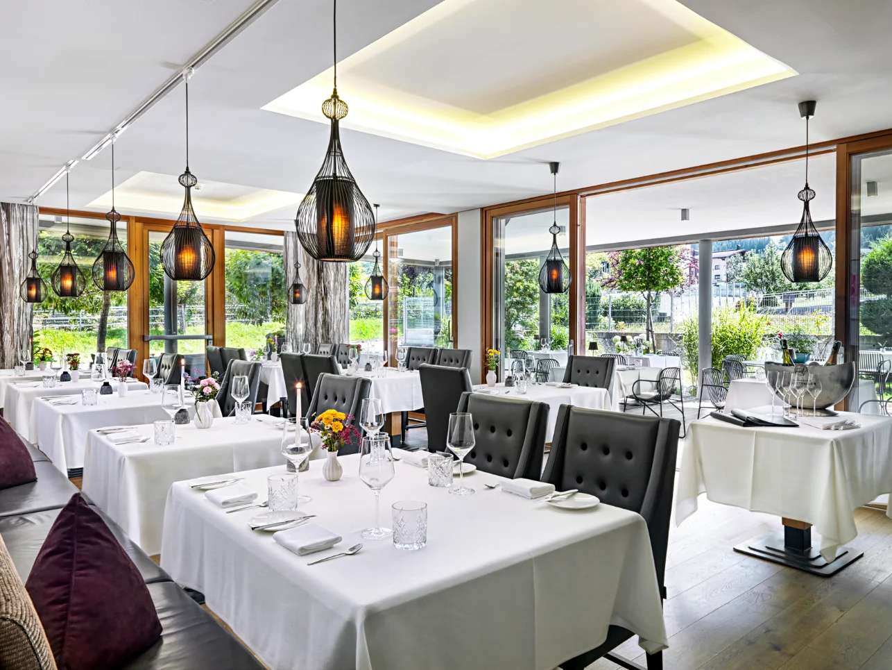 Huber's Boutique elegant dining room with large windows at the Mayrhofen boutique hotel.