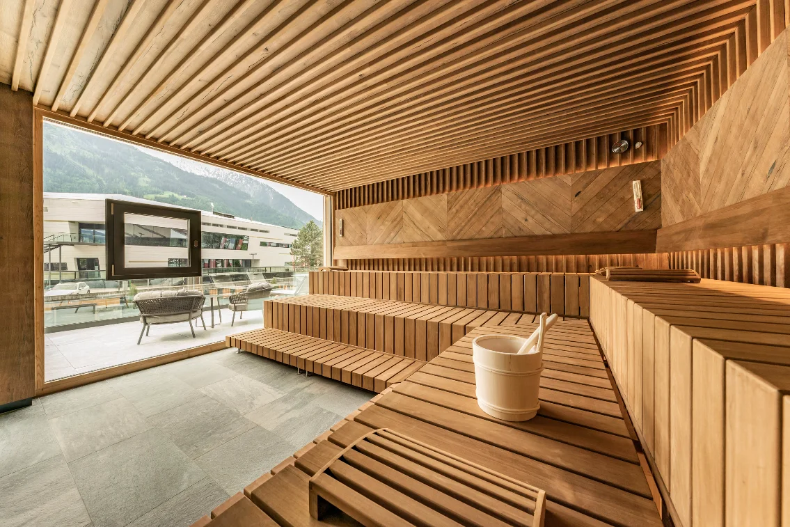 Berghof modern wooden sauna with mountain view at the Mayrhofen four-star hotel.