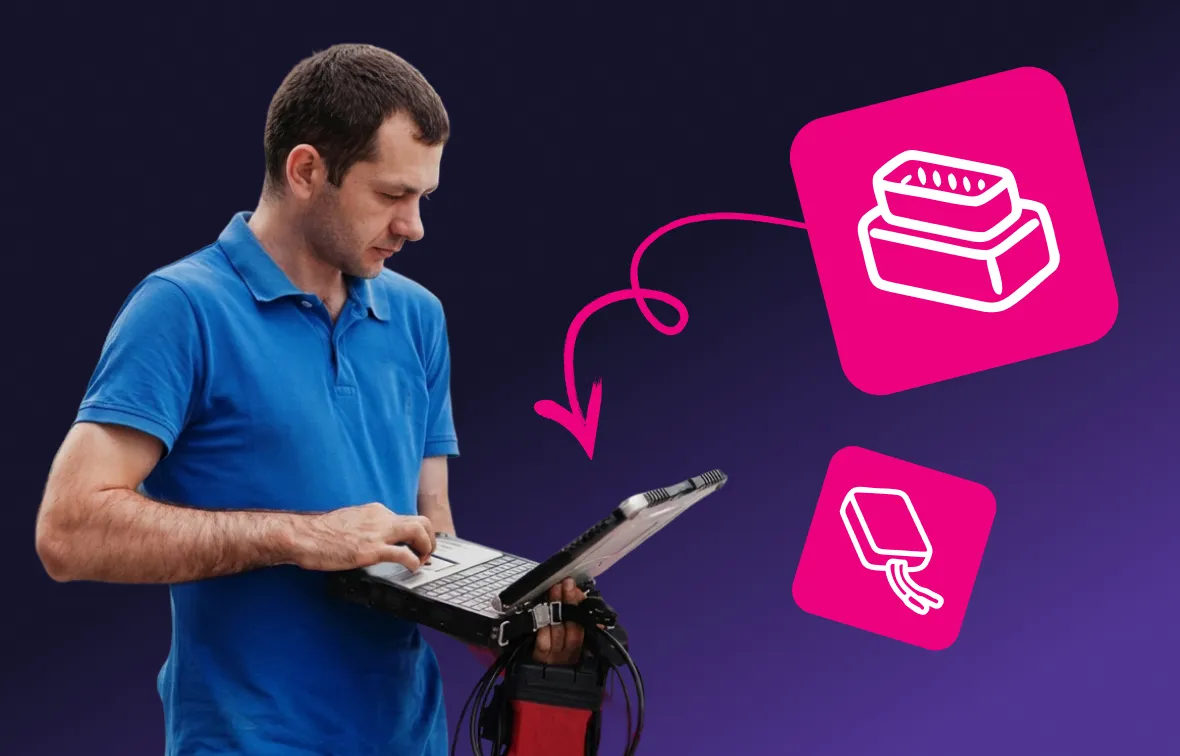 Man in blue polo shirt holding a laptop and device with cables, with icons of an OBD-II connector and tracking unit connected by an arrow.