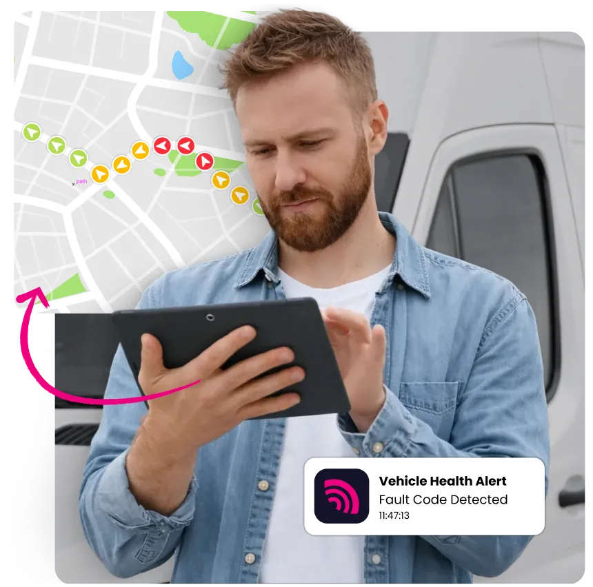 Man in denim shirt using a tablet with a vehicle health alert and a map route in the background.